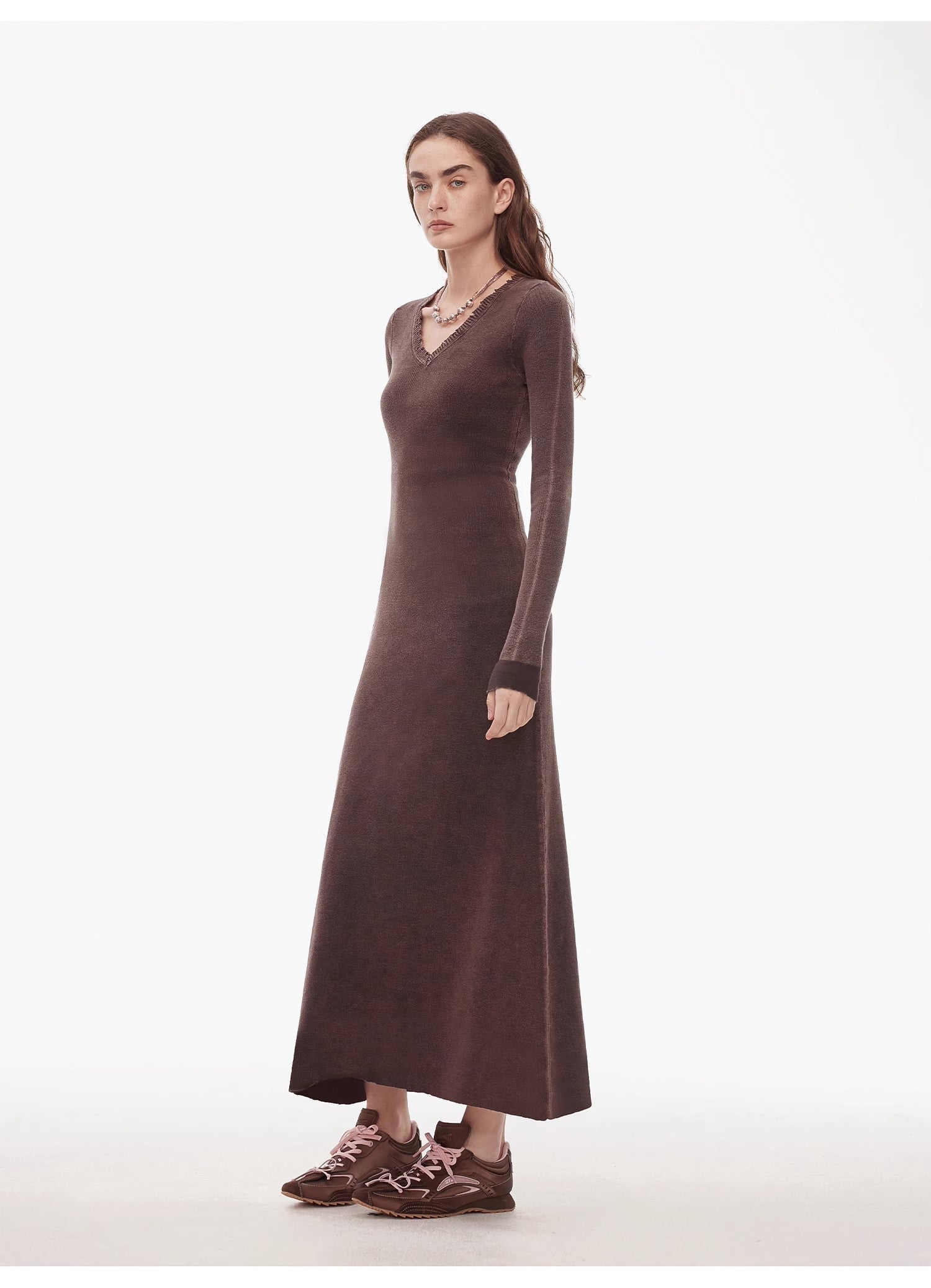 Woman wearing Selvara Distressed Cotton V-Neck Dress in dark texture with contrast cuffs