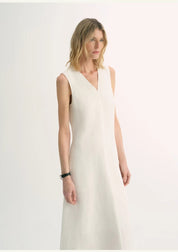 Model wearing Aurevae Cupro-Linen A-Line Dress with V-neck and sleeveless bodice, showcasing light, breathable fabric with subtle sheen.