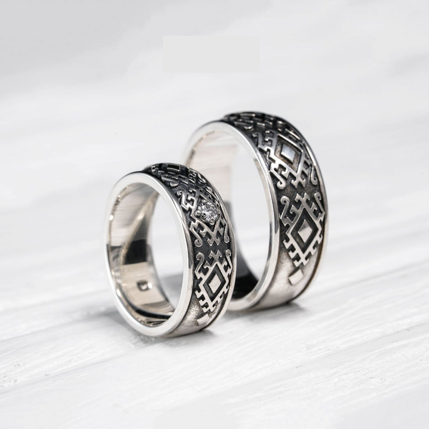 Sterling silver "Carpathian Harmony" wedding rings with oxidized finish, featuring Hutsul-inspired design and natural diamond.