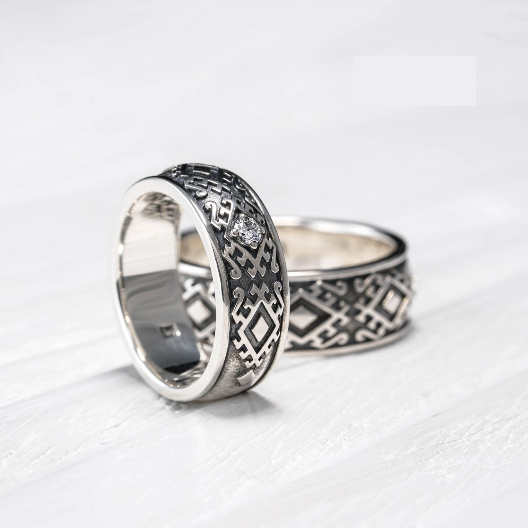 Sterling silver "Carpathian Harmony" wedding rings with cultural Hutsul design and diamond, handcrafted in Ukraine.