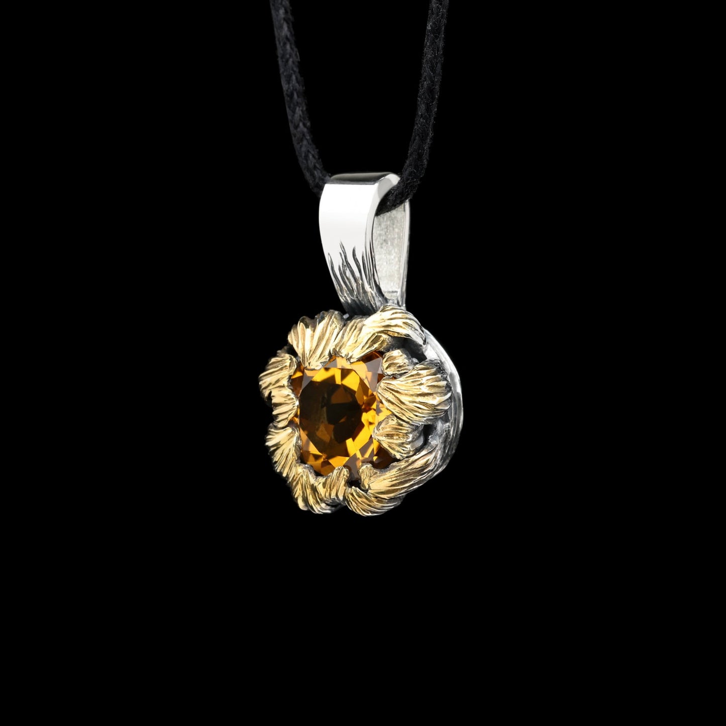 Golden Bloom pendant with citrine gemstone, sterling silver, and gilded details, inspired by peony petals, on black background.