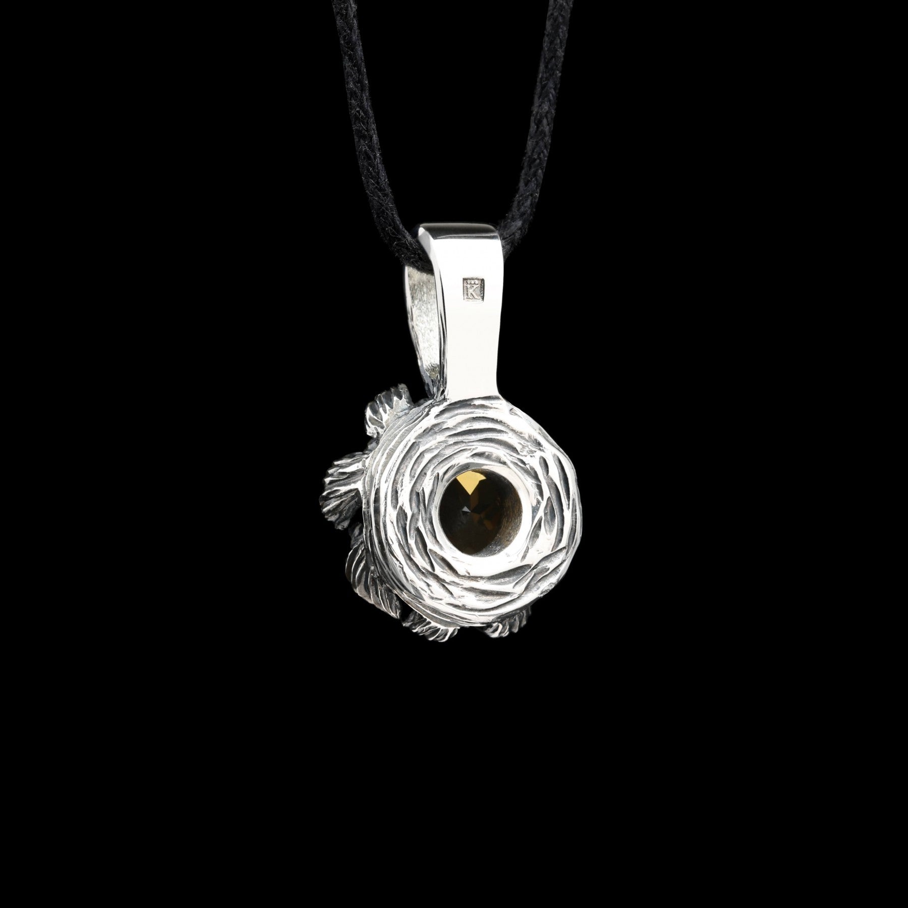 Sterling silver pendant with peony-inspired design and citrine gemstone, featuring gilded details on black background.