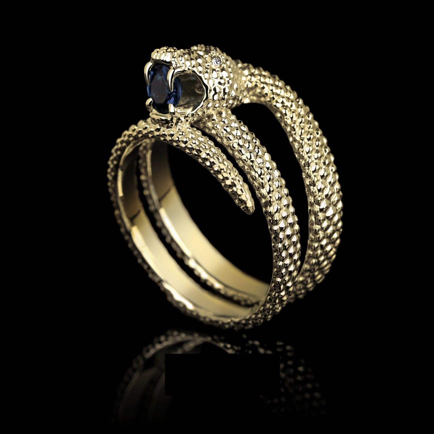 Yellow gold "Serpent Symphony" ring with blue sapphire and diamond, featuring intricate snake design, symbolizing elegance and strength.