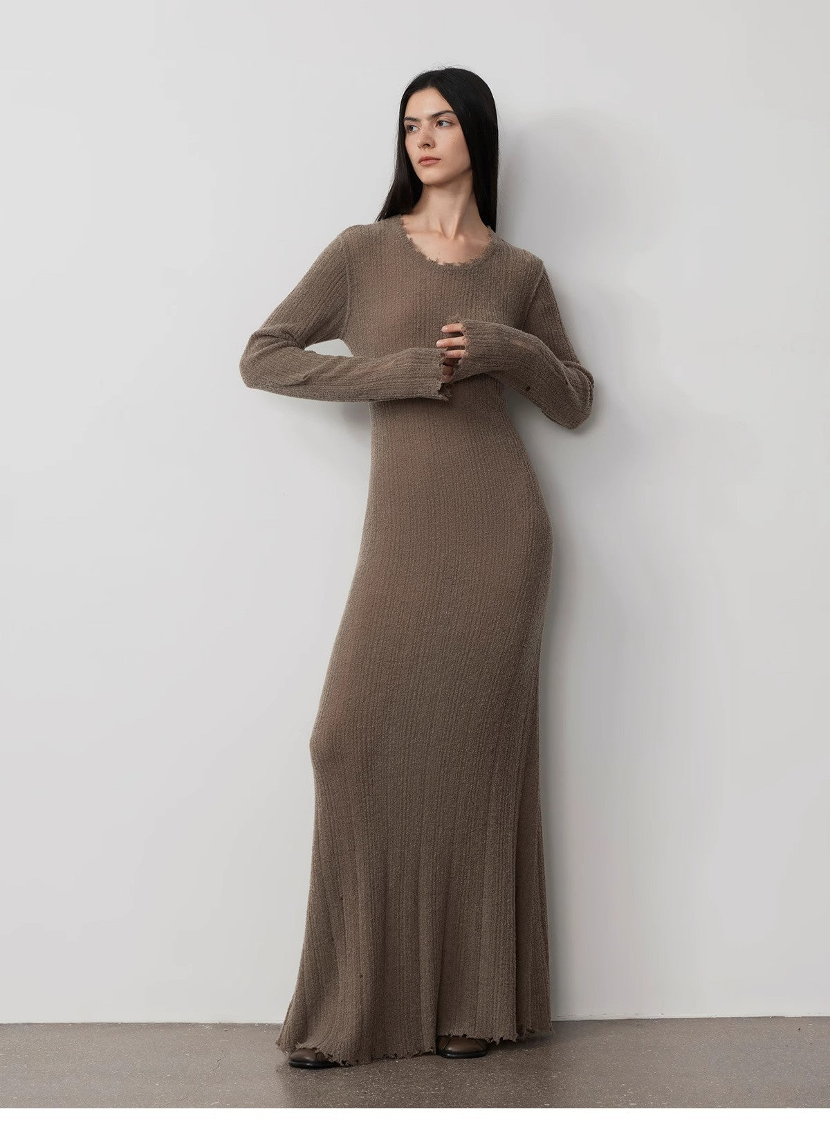 Model wearing Fray Line Wool Knit Dress with raw hem and subtle cut-outs, showcasing modern style and comfort.