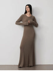 Model wearing Fray Line Wool Knit Dress with raw hem and subtle cut-outs, showcasing modern style and comfort.