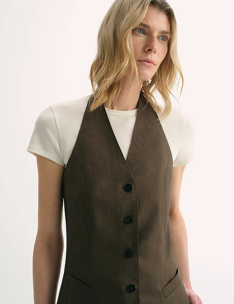 Woman wearing Solianne Silklinen Halter Vest in brown, showcasing a fitted cut with V neckline, styled elegantly over a T-shirt.