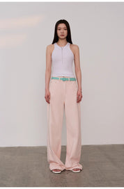 Woman wearing Isvera Slim Cotton Camisole paired with pastel pink wide-leg pants and turquoise belt, showcasing fashionable summer look.