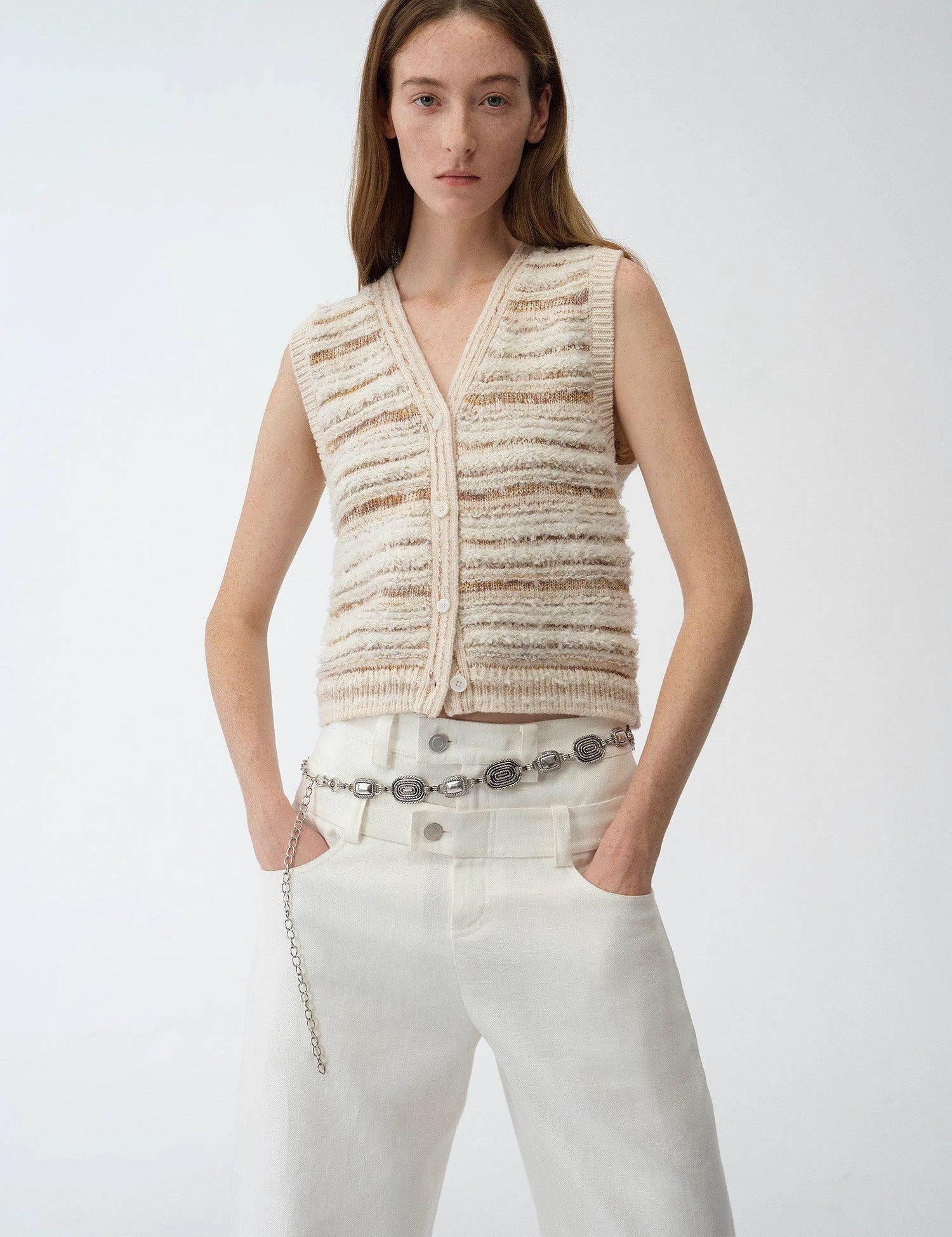 Model wearing Thalurea Stripeweave Vest showcasing textured floral yarns with luminous threads, perfect for spring fashion.