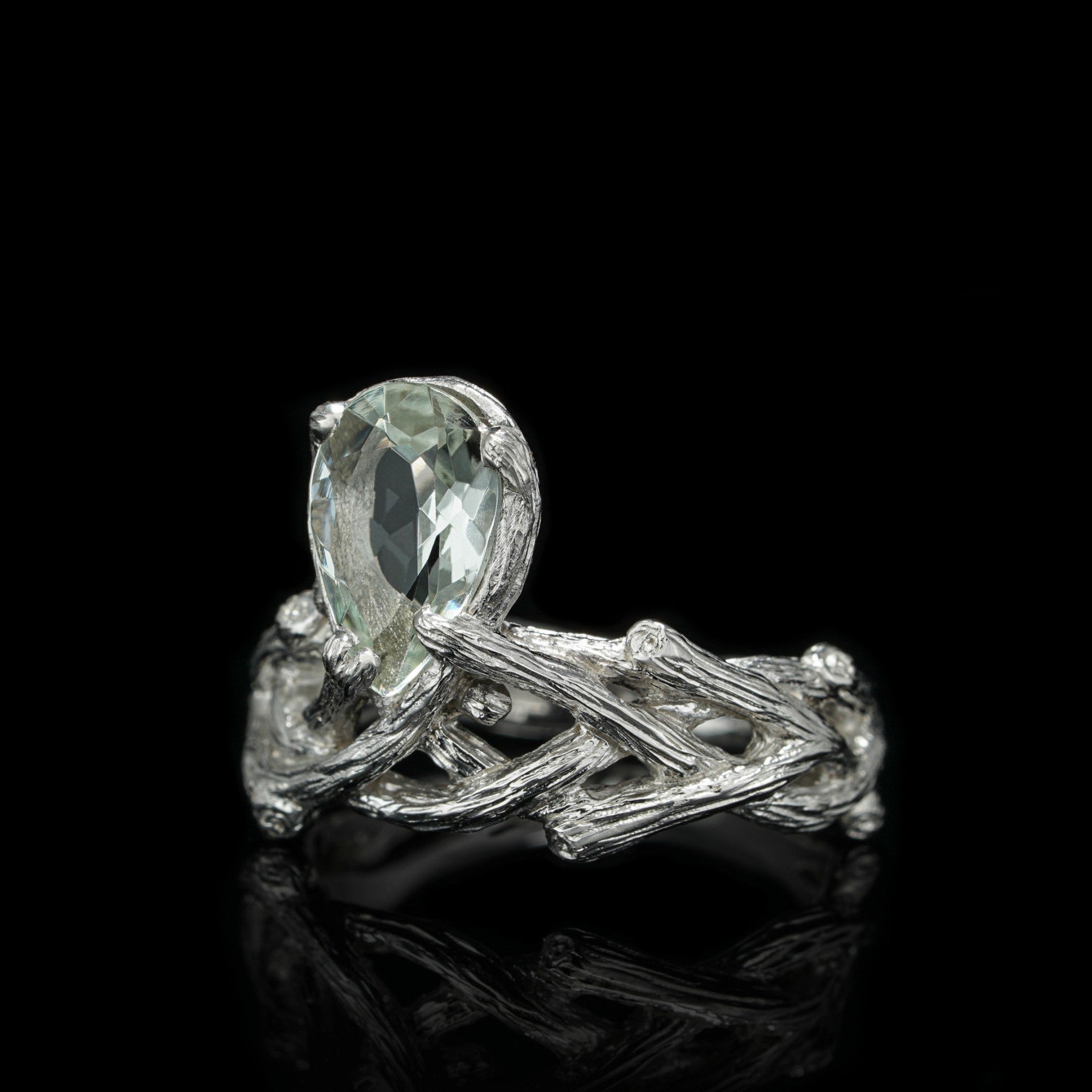 Sterling silver ring with green amethyst, Verdant Grace, featuring elegant rhodium finish against black background.