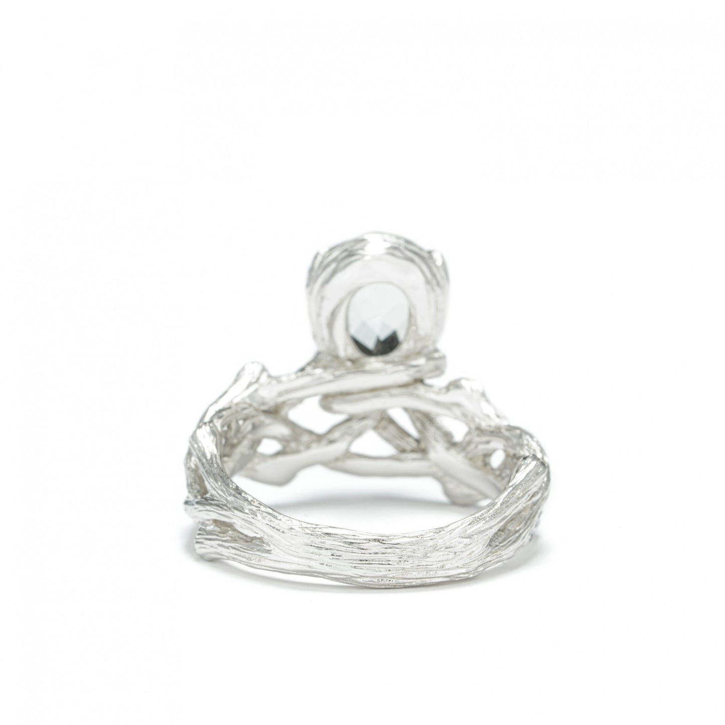 Sterling silver ring with white rhodium plating and green amethyst centerpiece, designed for elegance and individuality.