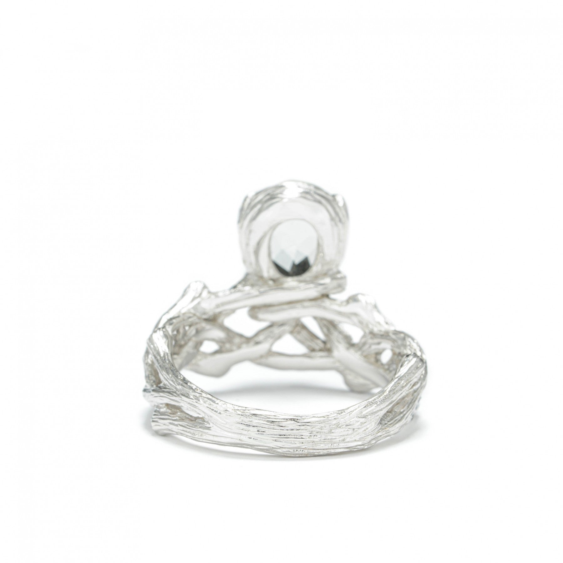 Sterling silver ring with white rhodium plating and green amethyst centerpiece, designed for elegance and individuality.