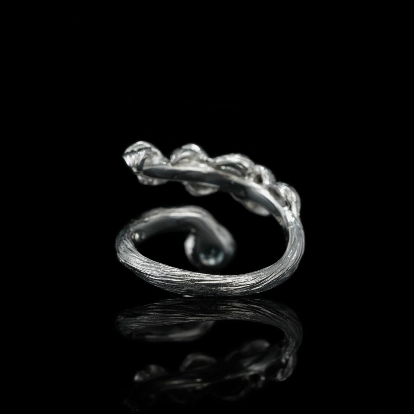 Sterling silver Blossom Symphony ring with intricate detailing on black background.