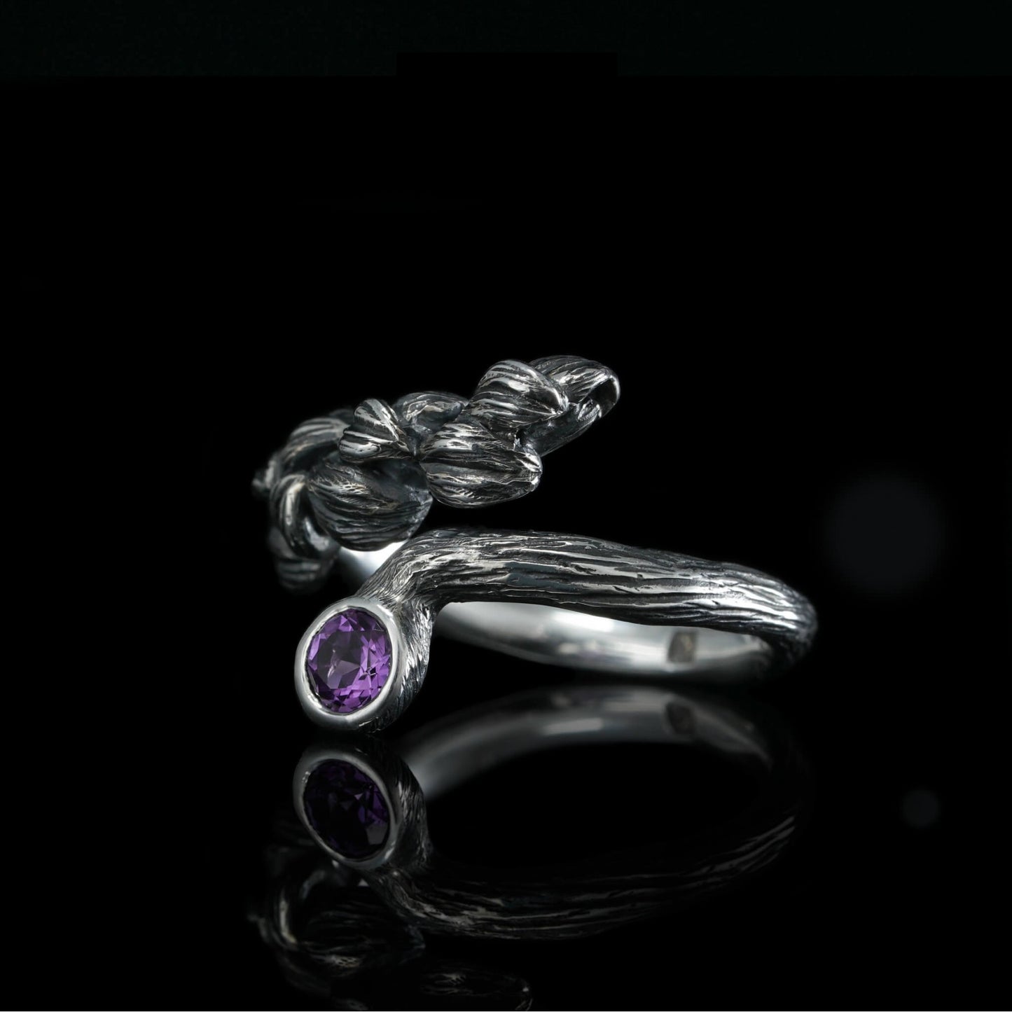 Sterling silver "Blossom Symphony" ring with amethyst, plated with white rhodium, showcasing elegant and natural design.