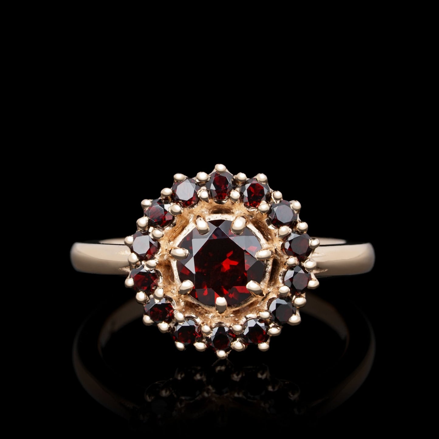 Elegant Fiery Allure ring in red 14K gold with central garnet and 13 accent stones, showcasing luxurious design and craftsmanship.