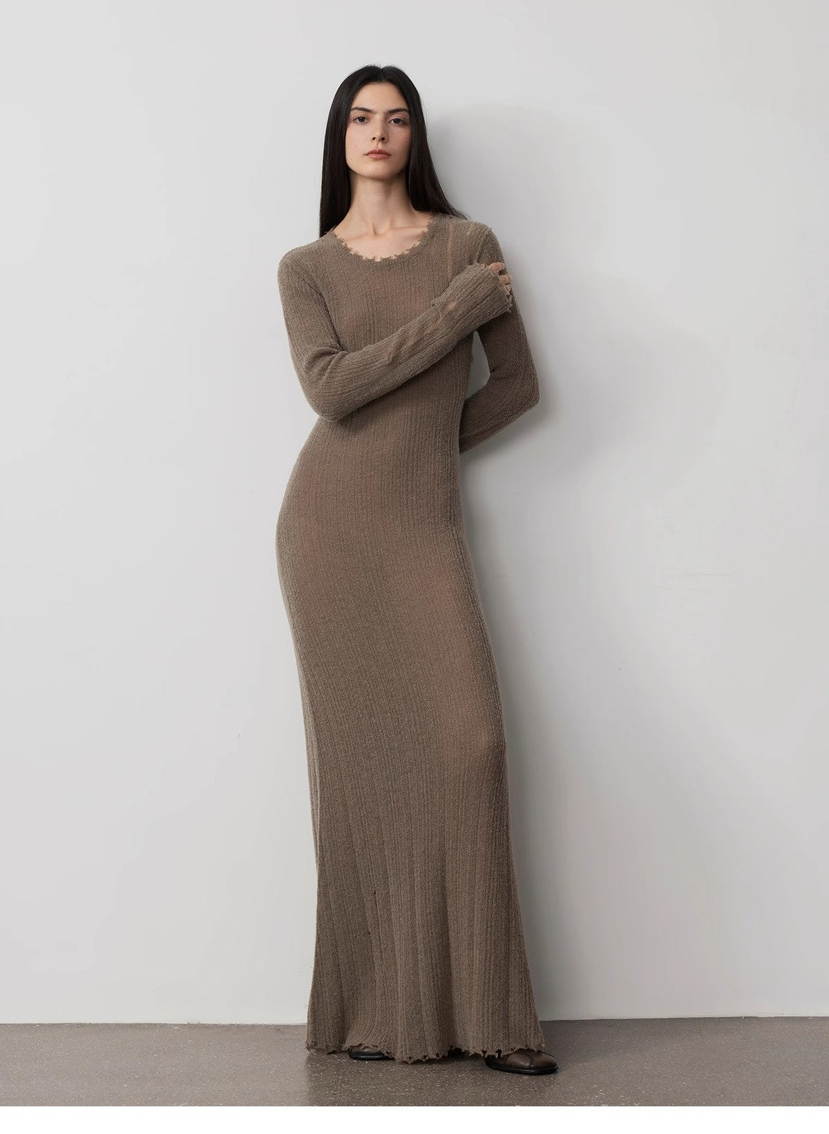 Woman wearing Fray Line Wool Knit Dress with frayed edges and body cut-outs, showcasing a modern, sculptural silhouette.