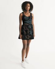 Woman wearing Shelllight Skater Dress with coastal shell design, scoop neckline, and shirred skirt, perfect for summer outings.