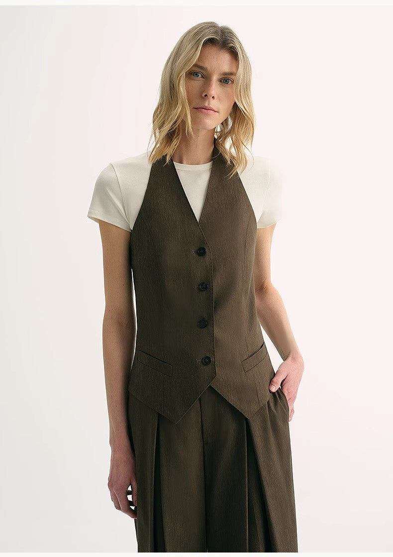 Model wearing a Solianne Silklinen Halter vest in brown, highlighting tailored fit, V neckline, and sculpted shoulders for elegant style.