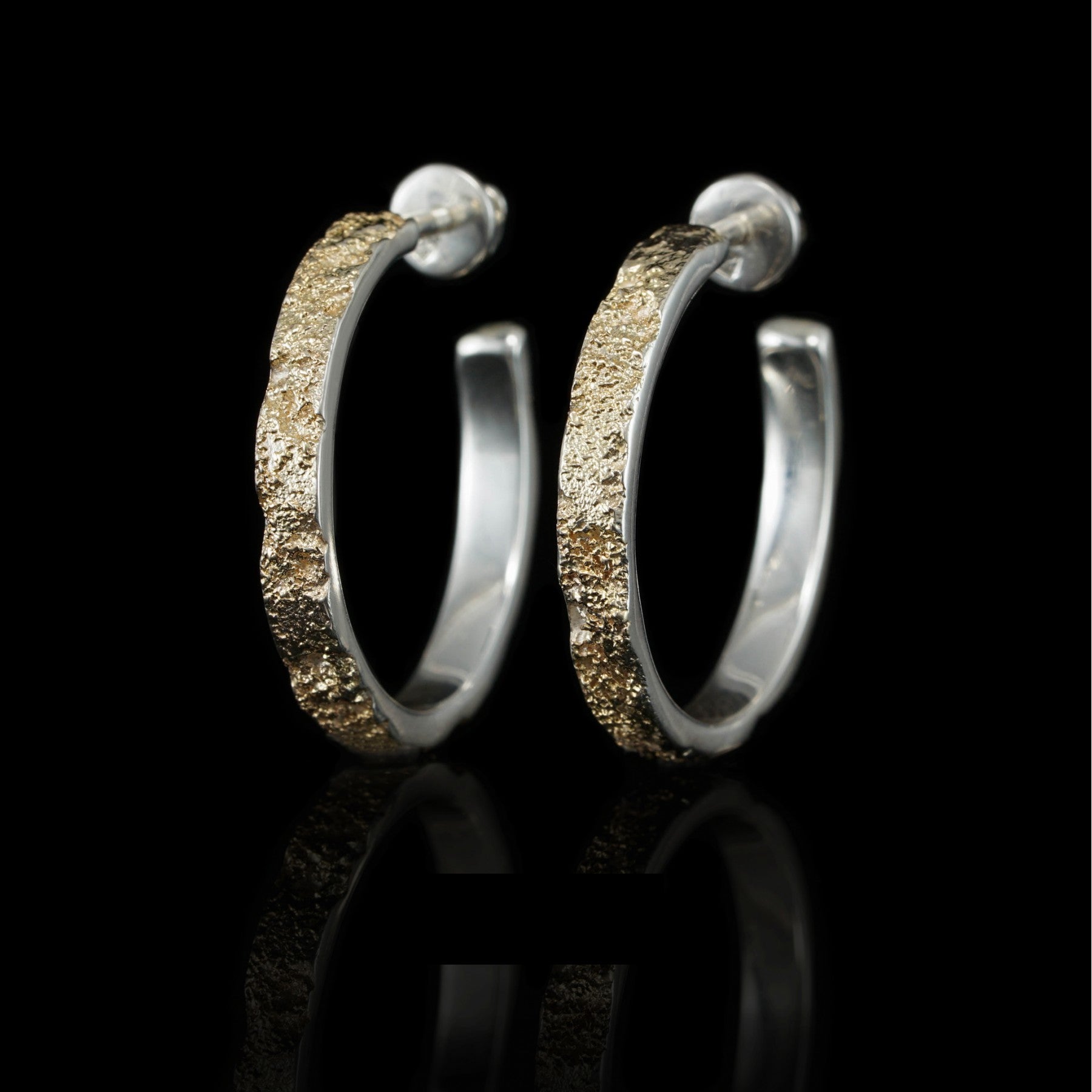 Sterling silver and 14K yellow gold "Golden Symphony" earrings, showcasing a striking two-tone design on a black background.