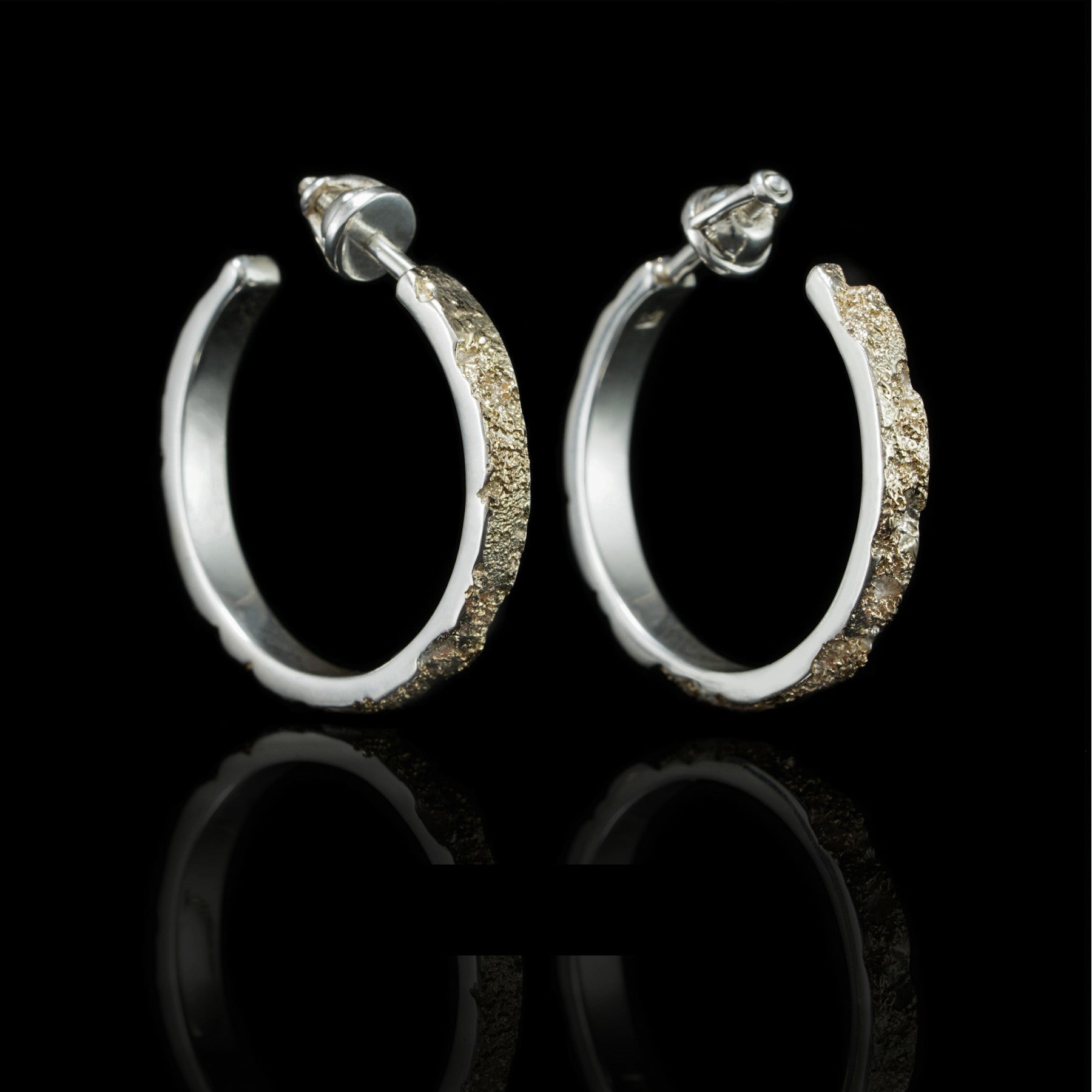 Golden Symphony earrings featuring sterling silver hoops with 14K yellow gold accents, showcasing elegance and harmony.