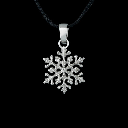 Sterling silver snowflake pendant "Winter’s Grace" with diamond, nature-inspired design on black background.