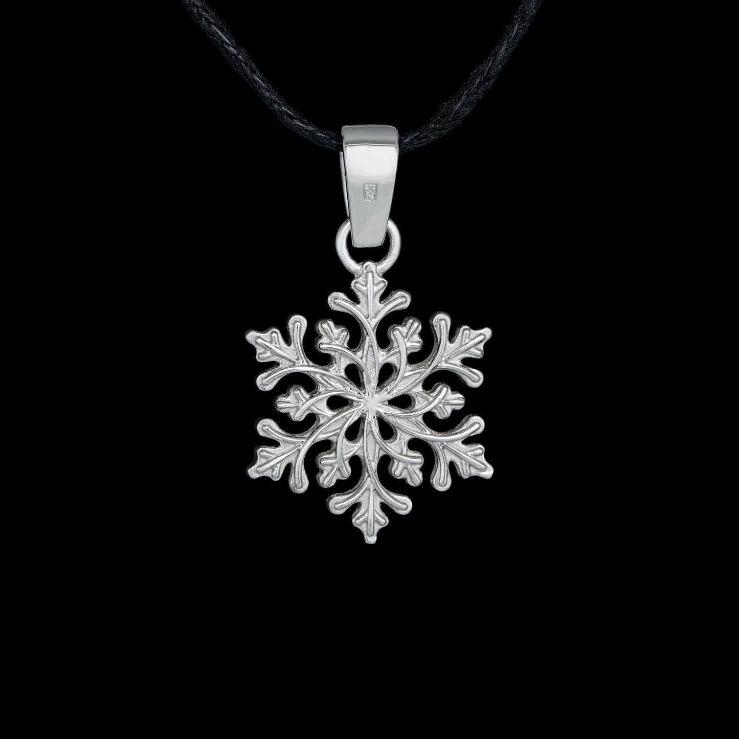 Sterling silver snowflake pendant "Winter's Grace" with diamond detail, nature-inspired design, and rhodium plating against black background.