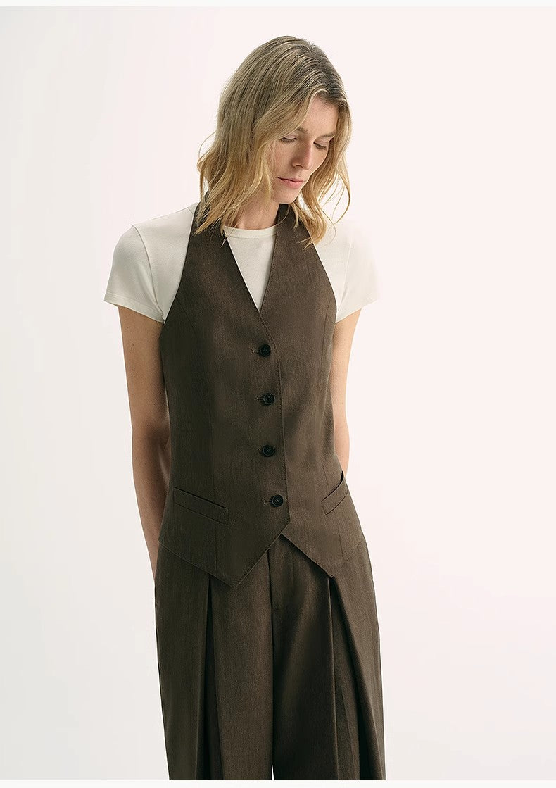 Woman wearing Solianne Silklinen Halter vest in brown Tencel-linen, showcasing elegant tailoring and refined fit.