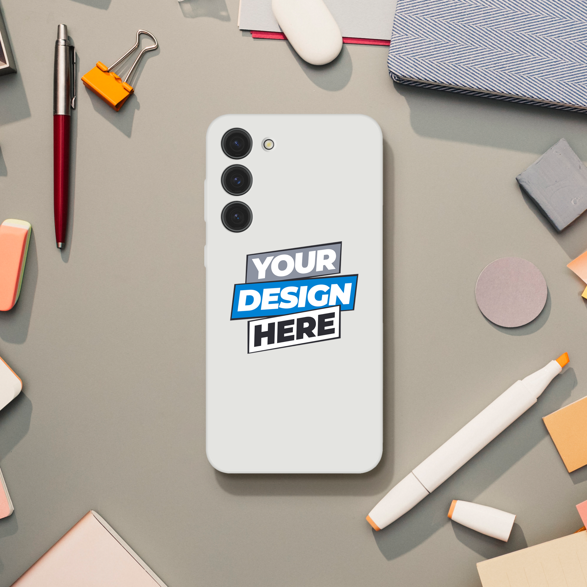 Transparent flexi phone case with custom design, surrounded by office supplies on desk.