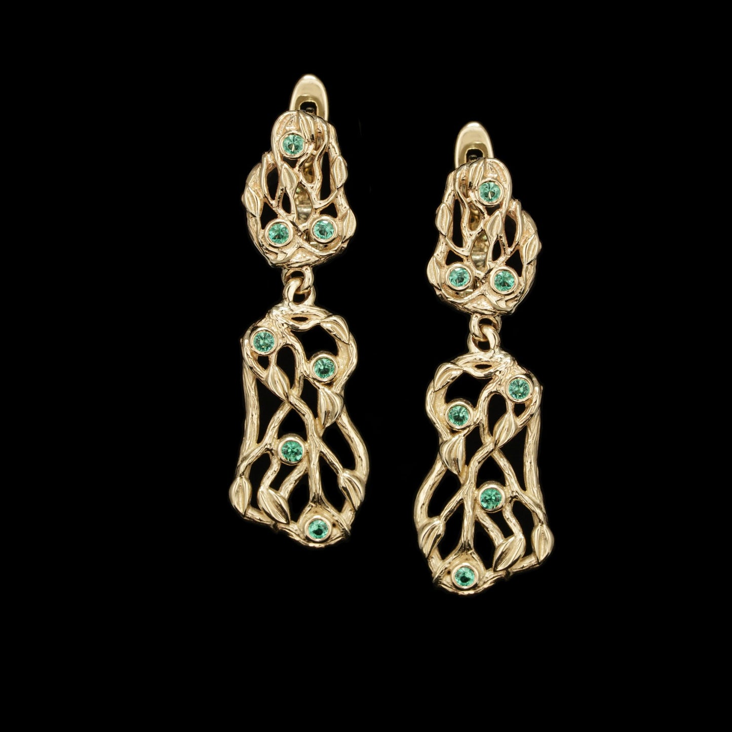 Yellow gold earrings with emerald gemstones from the Forest Whisper collection, featuring a dynamic design and luxurious appeal.