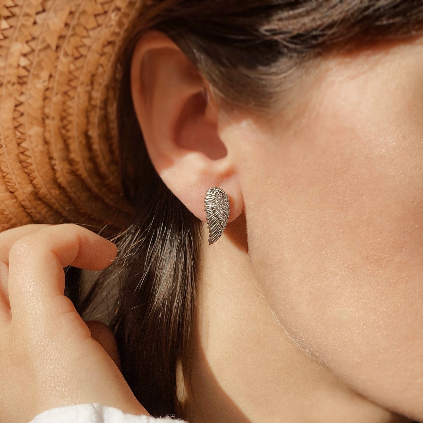 Close-up of a woman wearing "Regal Grace" sterling silver earrings, designed for elegance and sophistication.