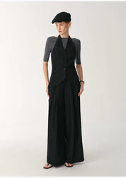 Model wearing Solianne Silklinen Halter vest with black structured cut and V neckline, paired with wide-leg trousers, exuding elegance.