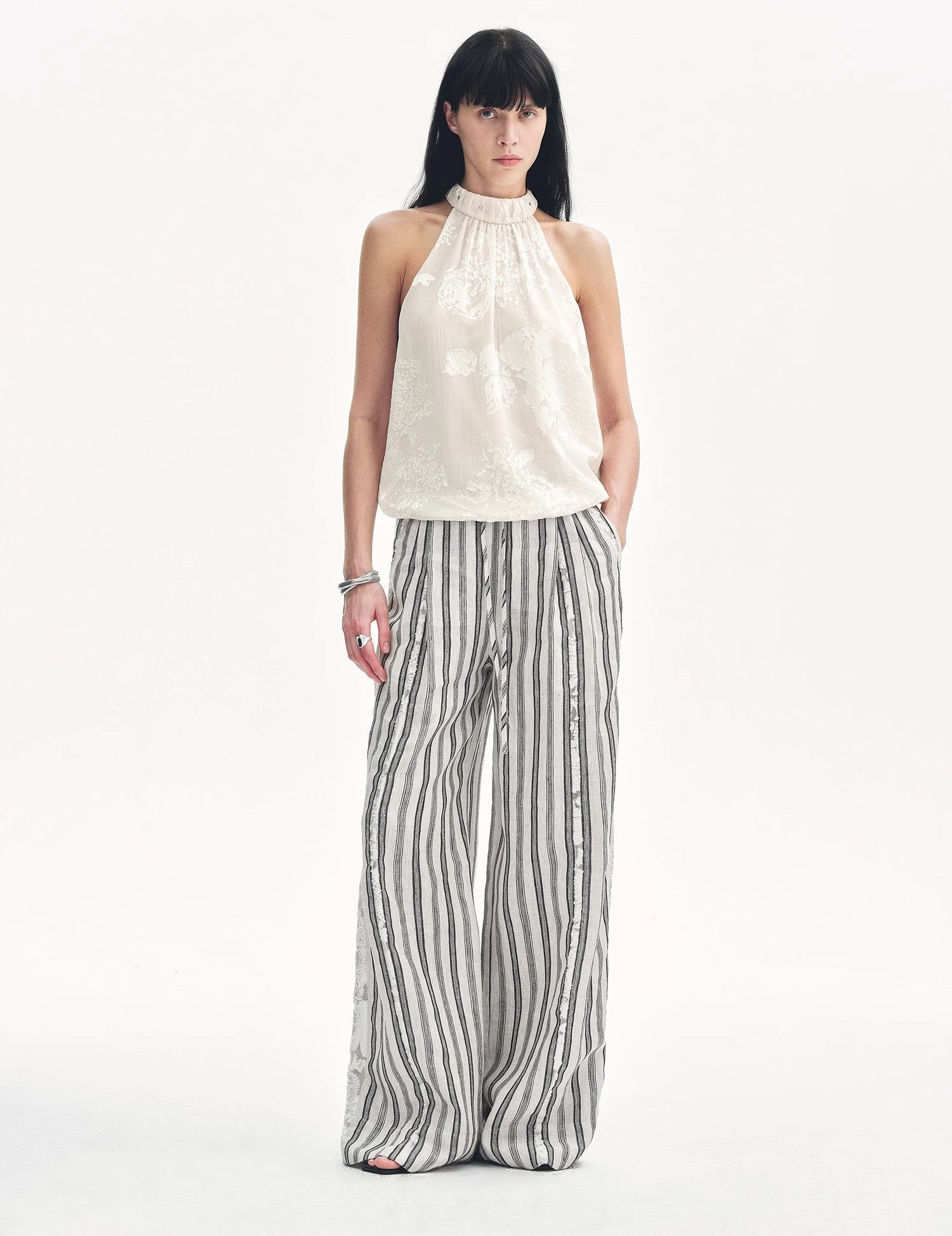 Elireth Burnt-Floral Halter with pleated A-line hem, showcasing sculpted elegance and petal-like textures for timeless style.