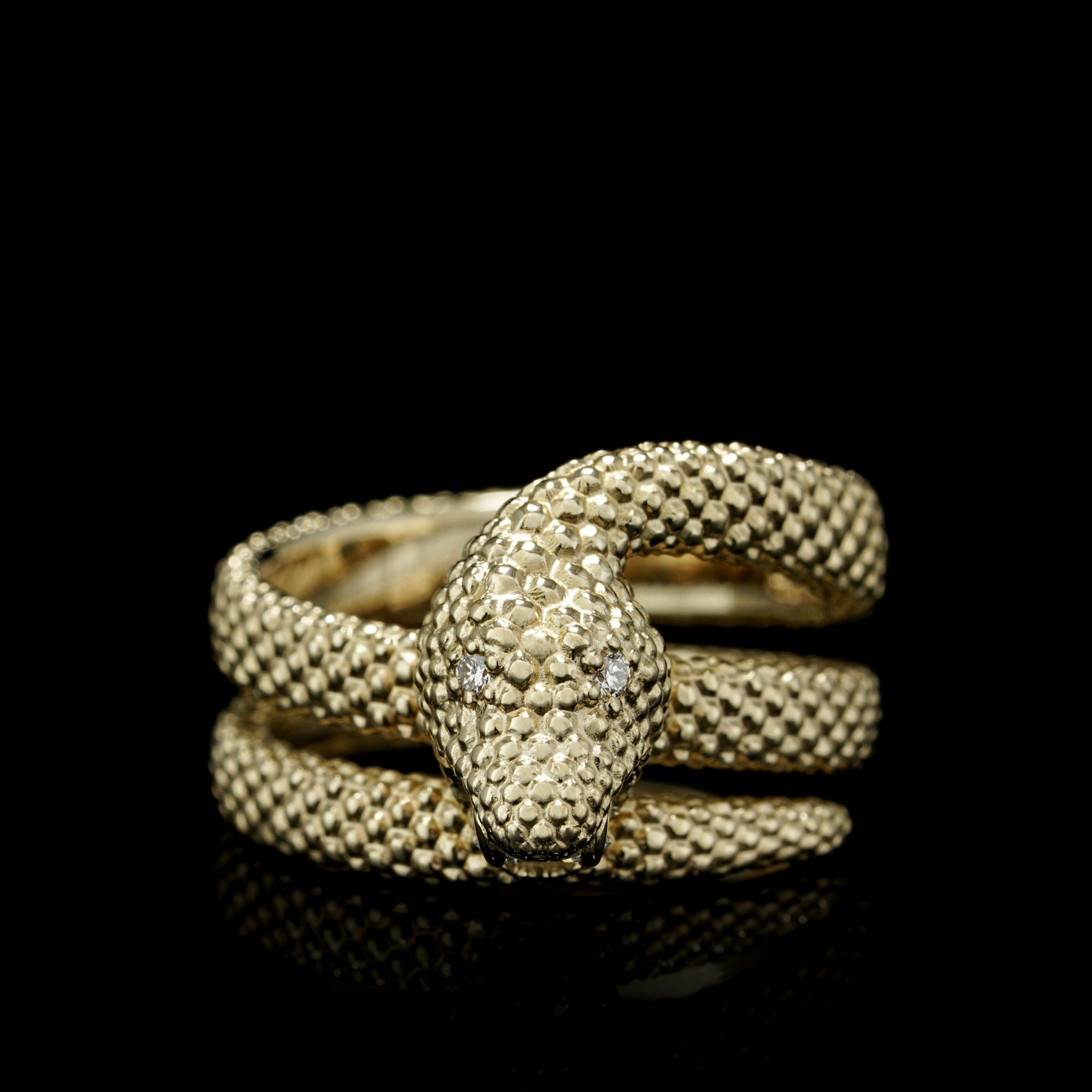 Yellow gold ring with intricate snake design, showcasing "Serpent Symphony" craftsmanship, symbolizing wisdom and transformation.