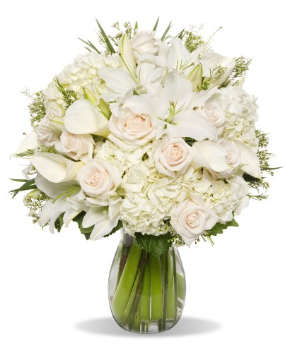 Elegant winter bouquet with 40 stems of hydrangeas, oriental lilies, roses, and calla lilies in a glass vase. Perfect holiday gift.