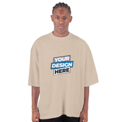 Men's oversized drop-shoulder crewneck t-shirt in beige with "Your Design Here" print, streetwear style.