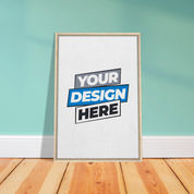 Framed canvas print with customizable design option, displayed on a wooden floor against a teal wall, promoting personalized art.