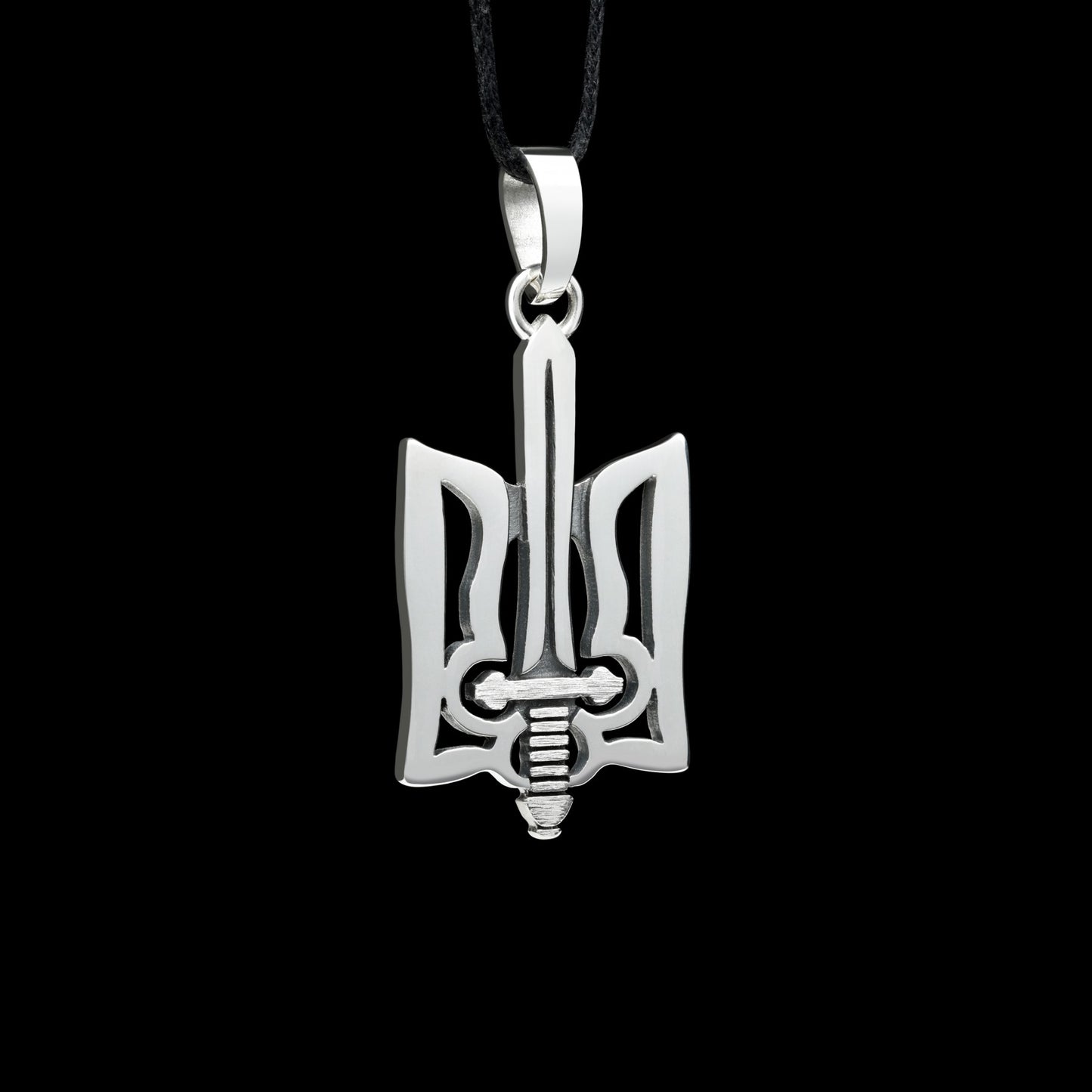 Sterling silver "Trizub with Sword" pendant, symbolizing Ukrainian heritage with oxidized finish, on black background.