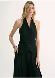 Woman wearing Solianne Silklinen Halter vest in black, showing structured fit, V neckline, and elegant tailoring.