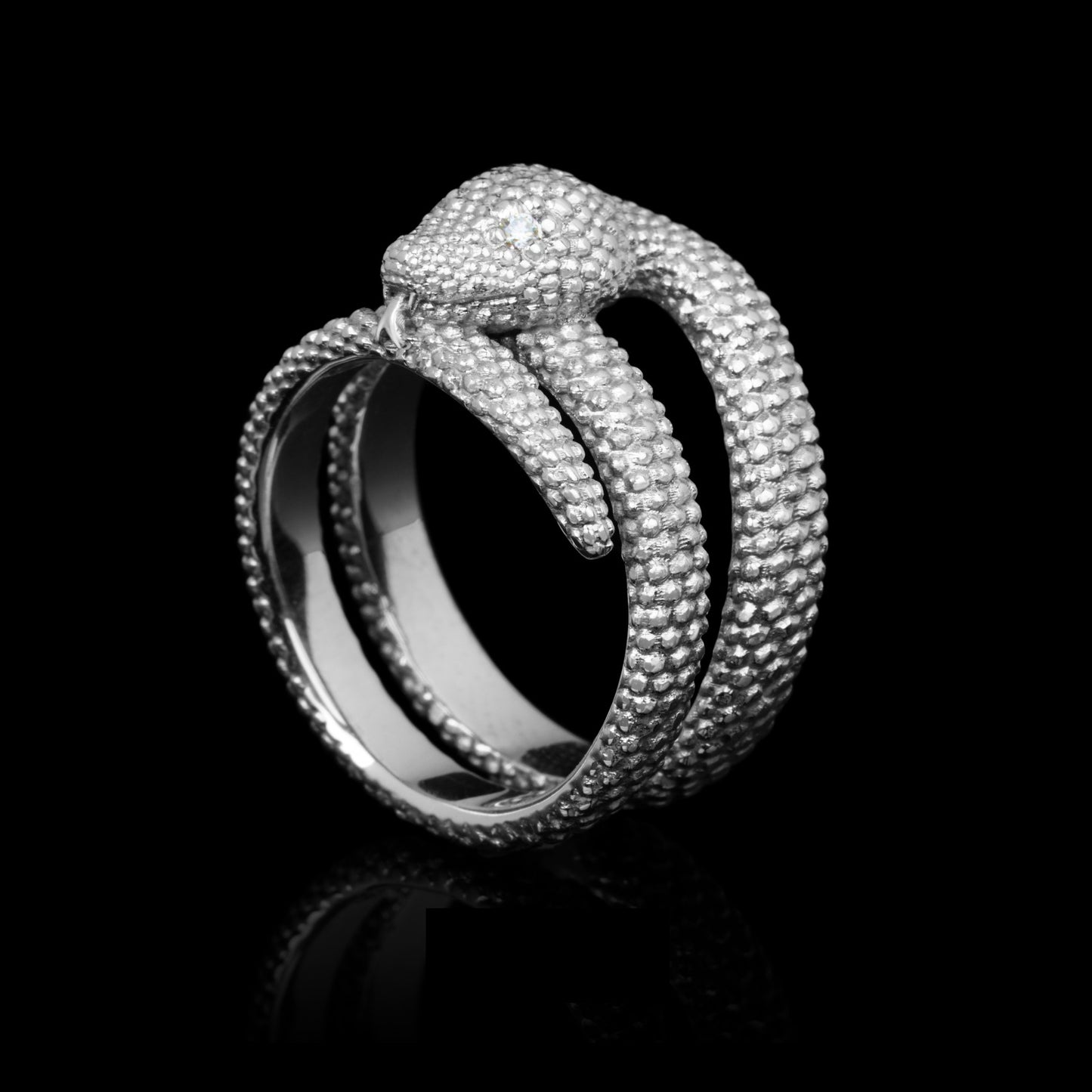 Elegant 14K white gold serpent-inspired ring with sparkling diamonds showcasing modern design on black background.