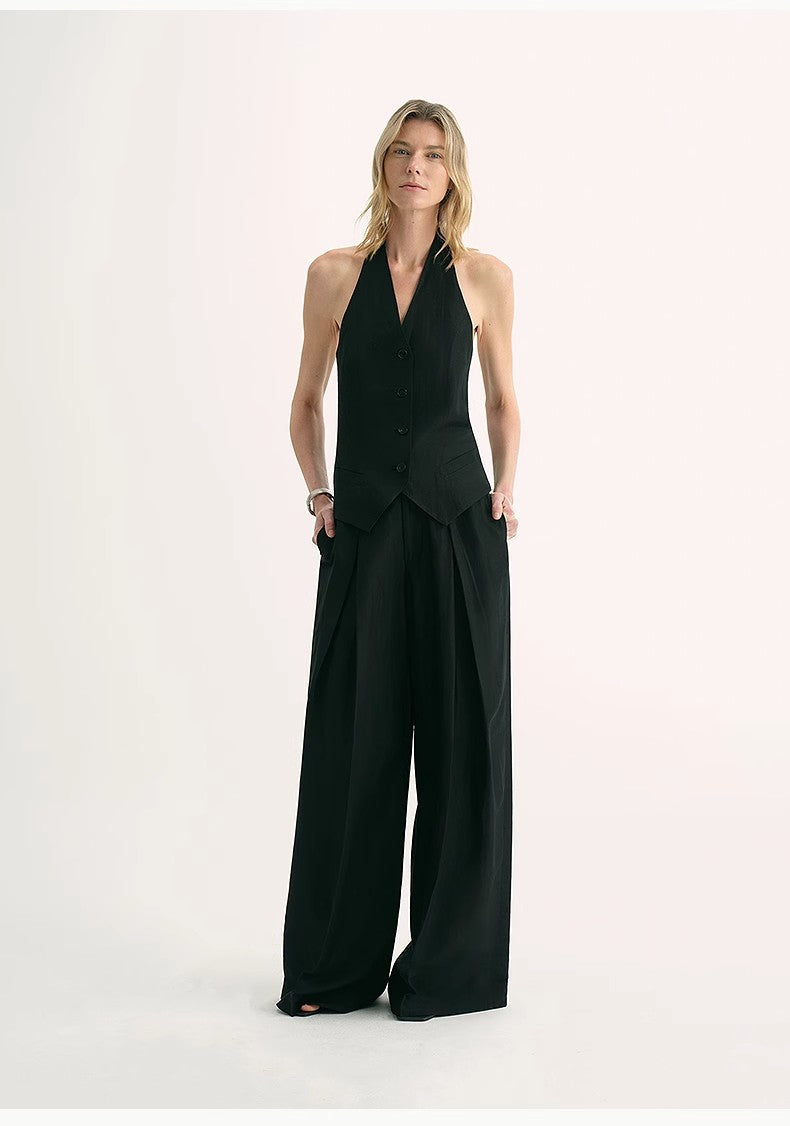 Model wearing Solianne Silklinen Halter in black, showcasing elegant V neckline and sculpted shoulders for refined summer styling.