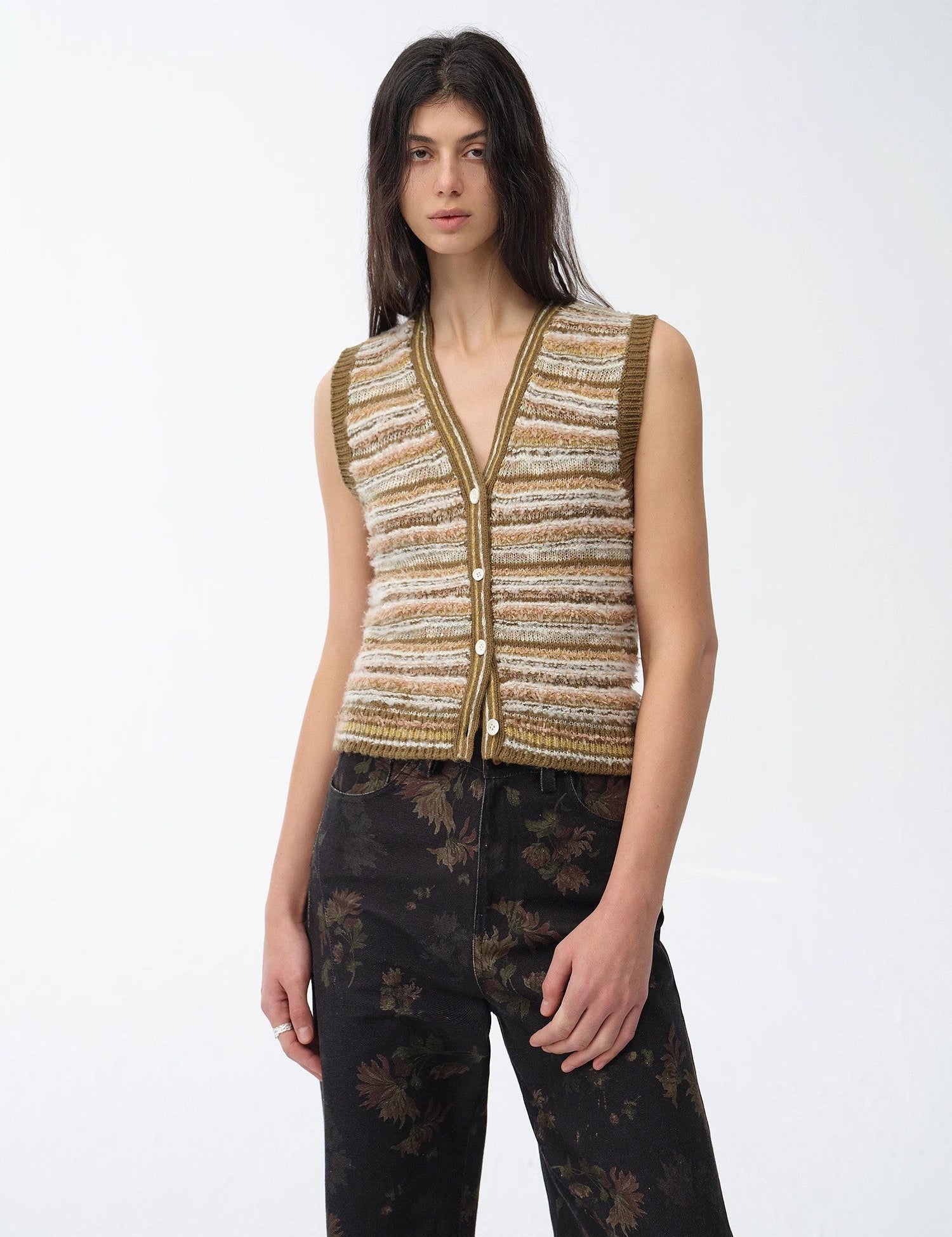 Woman wearing Thalurea Stripeweave Vest with floral stripe pattern, buttoned front, and V-neck style, evoking a springtime feel.
