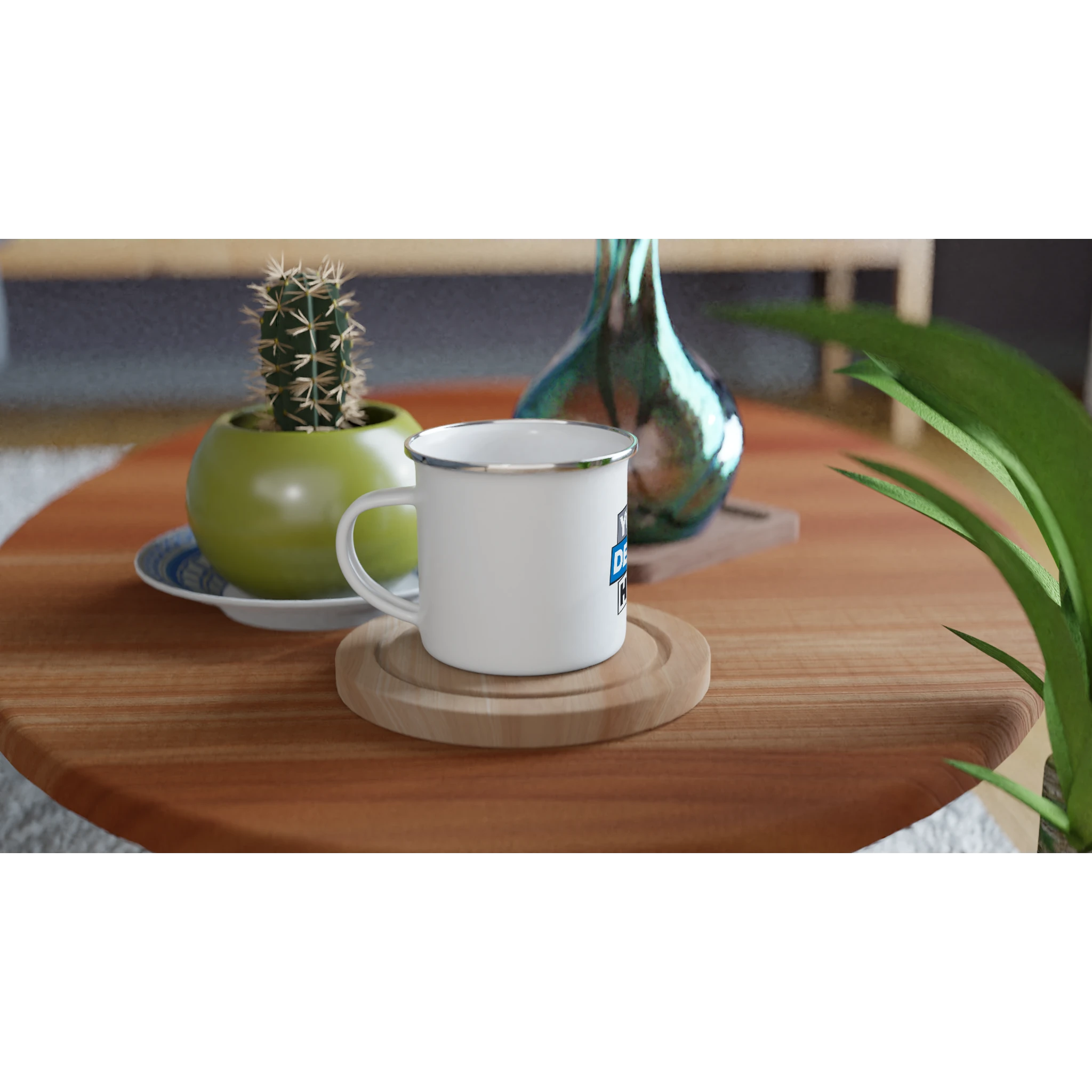 White enamel mug 12oz on a wooden table with decorative plants, showcasing its classic and lightweight camping-friendly design.