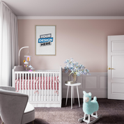 Modern nursery with white crib, pink accents, rocking horse, and customizable framed wall art