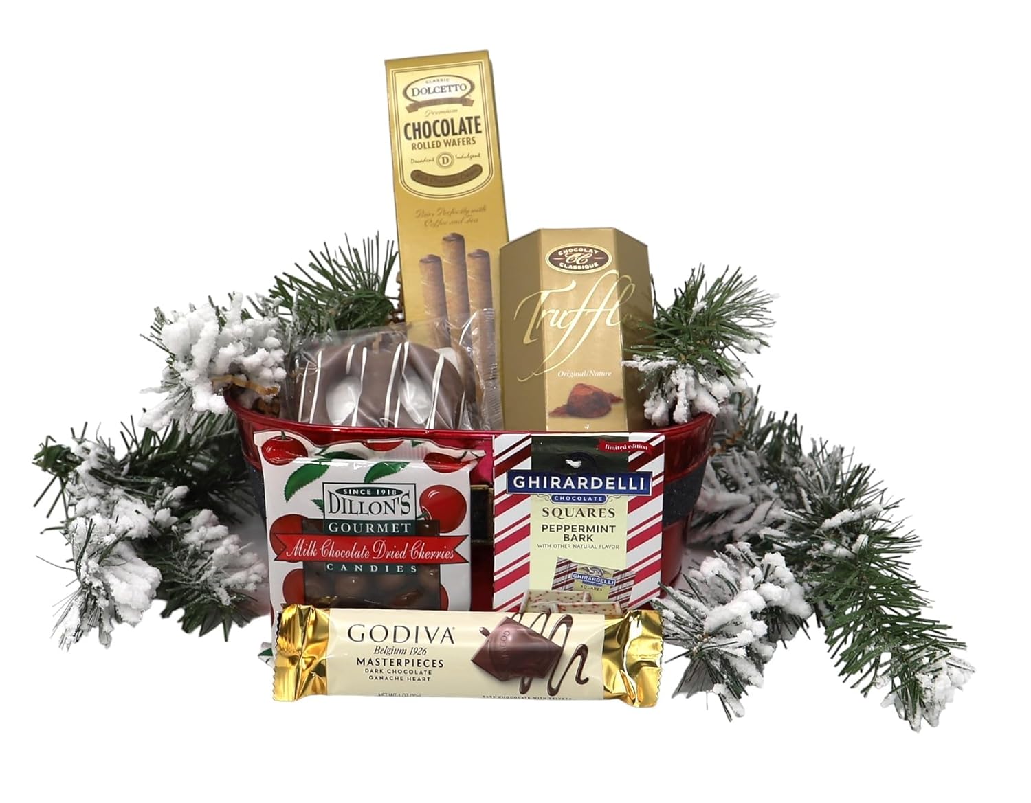 Holiday gift basket with chocolates, wafers, and festive sweets among pine branches for Christmas celebrations.