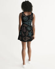 Woman wearing Shelllight Skater Dress with coastal shell pattern and scoop back, standing against a white background.