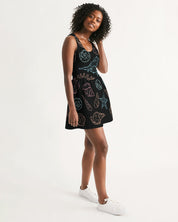 Woman wearing a Shelllight Skater Dress with coastal shell prints and a scoop neckline, standing in white sneakers against a plain background.
