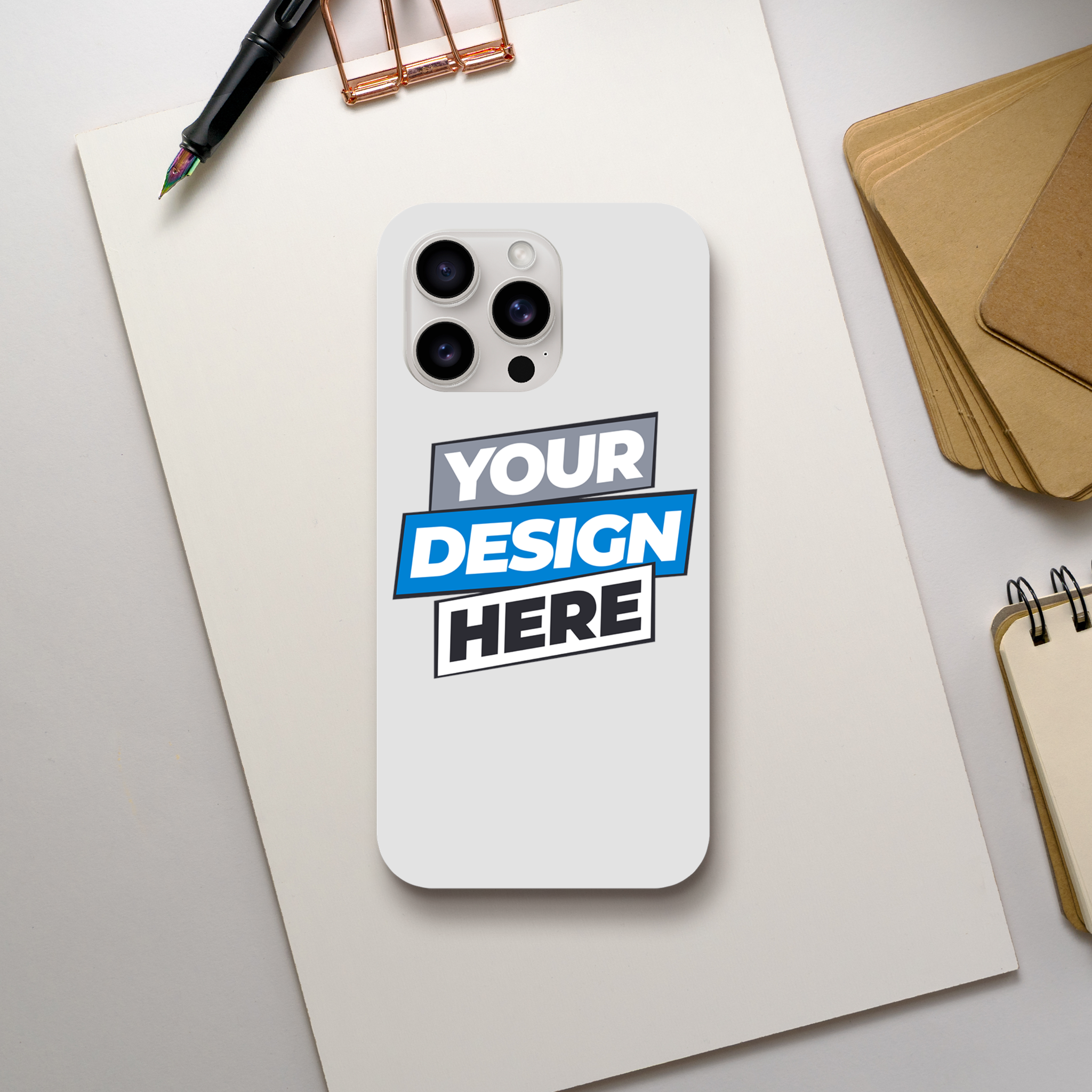 Customizable iPhone case displayed on desk with 'Your Design Here' text, showcasing sleek gloss finish and dual-layer protection.