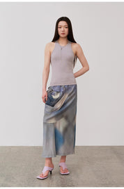 Woman wearing Isvera Slim Cotton Camisole with I-shaped neckline, paired with elegant skirt and sandals, showcasing chic summer fashion.