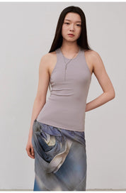 Woman wearing Isvera Slim Cotton Camisole in light gray, showcasing a flattering I-shaped neckline for a refined, elegant look.