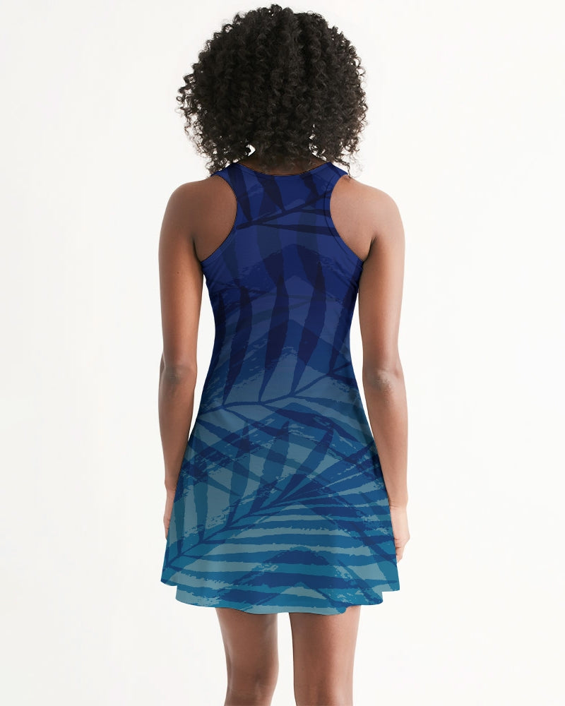 Woman wearing a Sunset Hour Racerback Dress with a blue pattern, highlighting a casual sleeveless design ideal for summer outings.