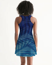 Woman wearing a Sunset Hour Racerback Dress with a blue pattern, highlighting a casual sleeveless design ideal for summer outings.